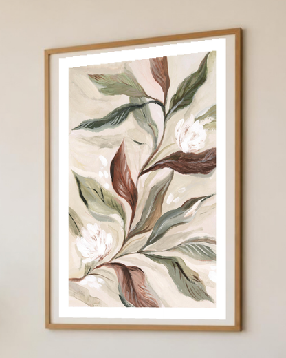 Affiche botanique encadrée sur un mur de salon, vue rapprochée des feuilles vert sauge et terracotta et des fleurs blanches